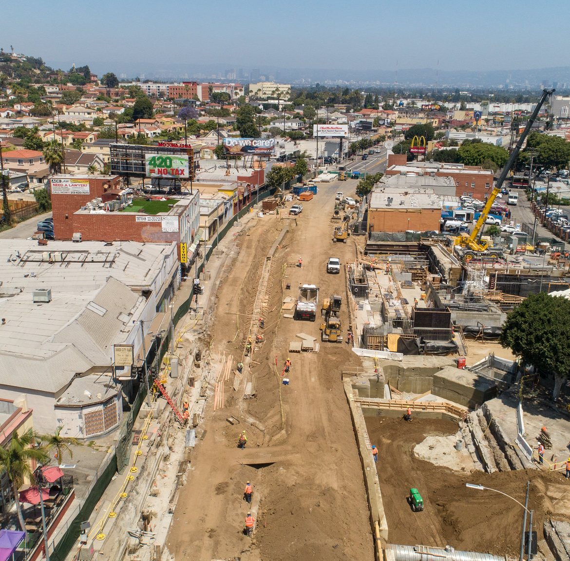 Bird's eye view of construction on a wide road in Los Angeles.