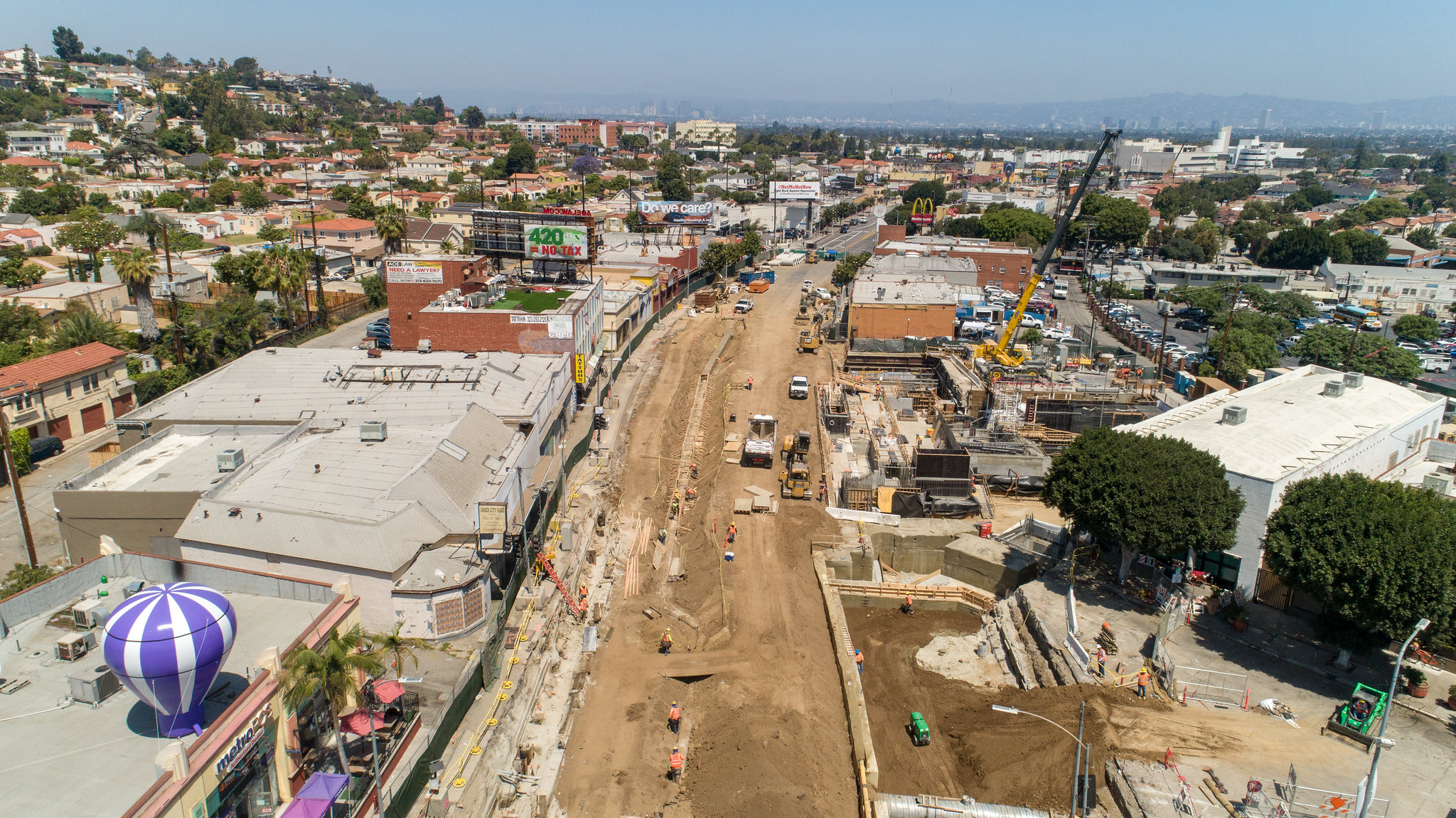 Bird's eye view of construction on a wide road in Los Angeles.