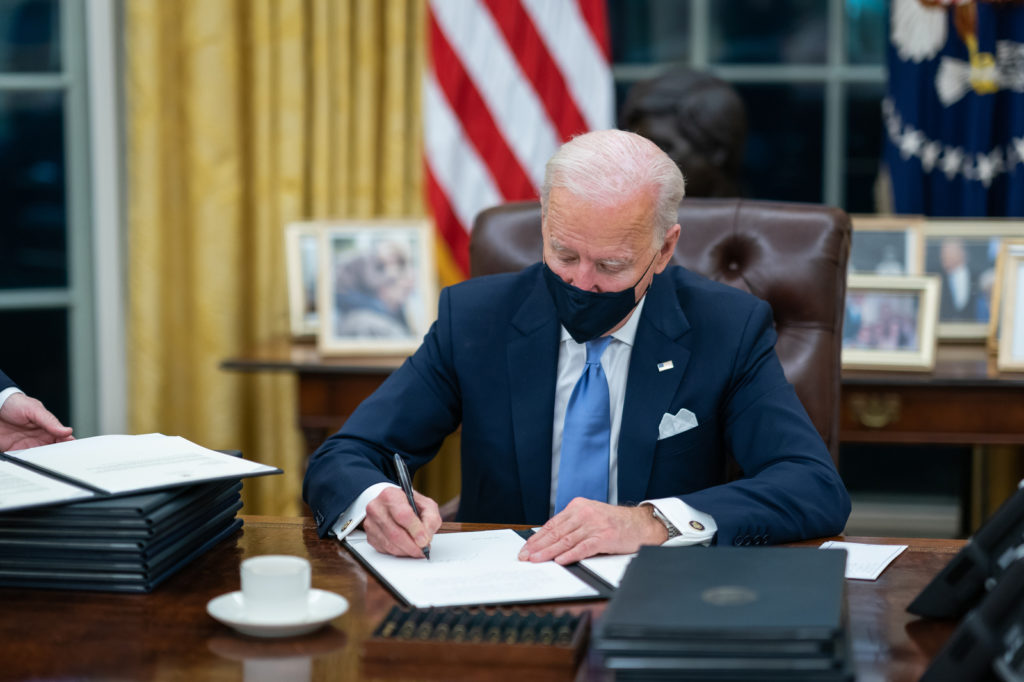 President Biden wears a mask as he signs executive orders