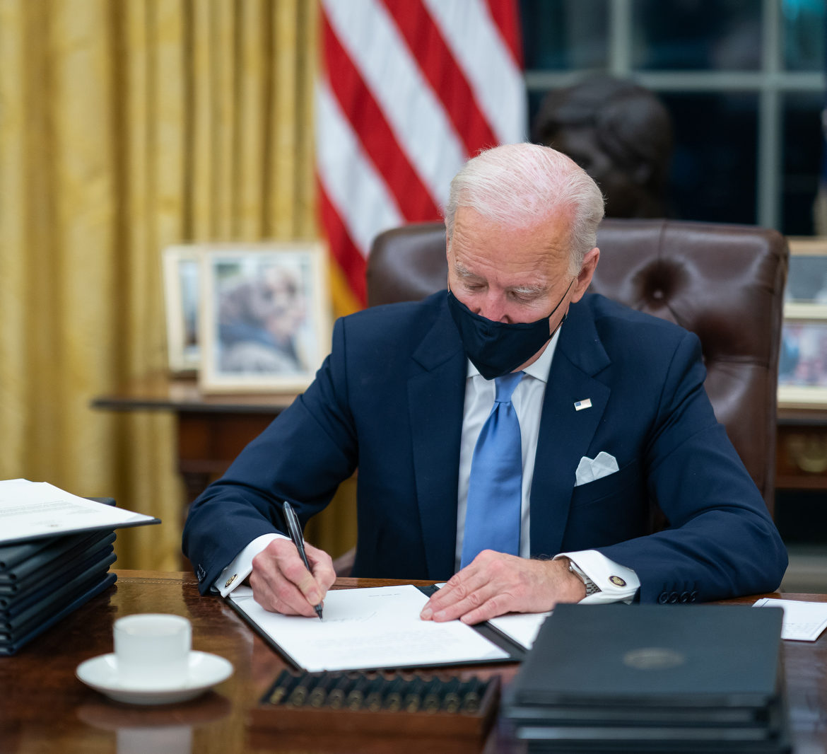 President Biden wears a mask as he signs executive orders