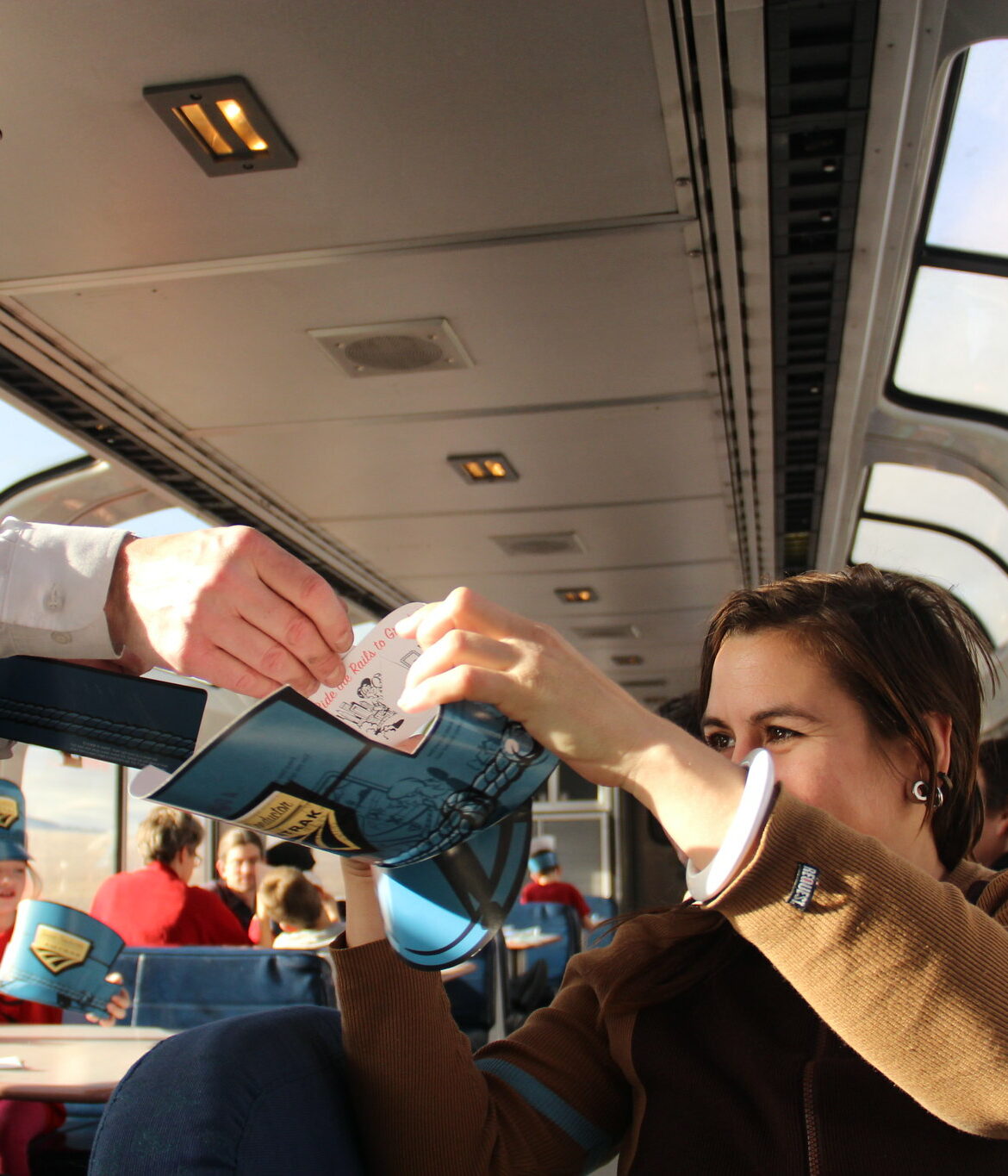 An Amtrak employee interacts with passengers on the train