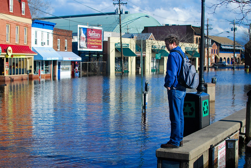 A man observes a stretch of Dock Street in Annapolis, Md., that flooded after the area received over three quarters of an inch of rain in 24 hours on Jan. 25, 2010.