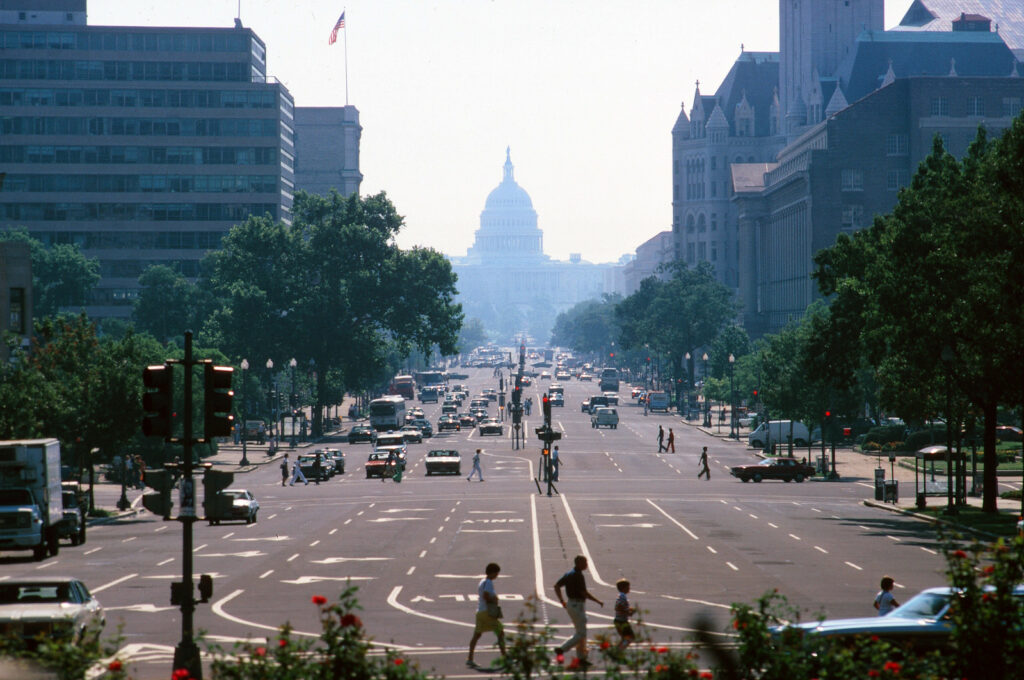 DC street with pedestrians, buses, and cars
