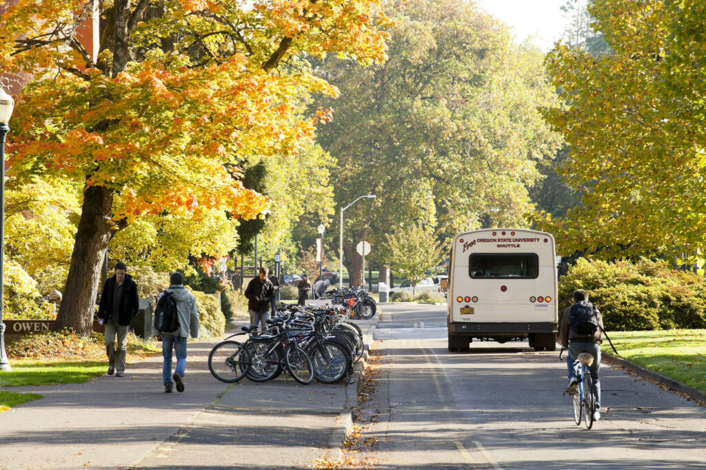 Pedestrians, cyclists, and transit riders navigate a busy street