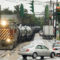 Two sedans break as a train approaches, unable to cross