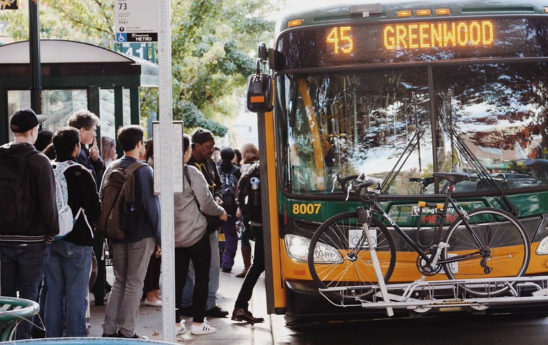 Transit riders representing a range of ethnicities board a bus in the state of Washington