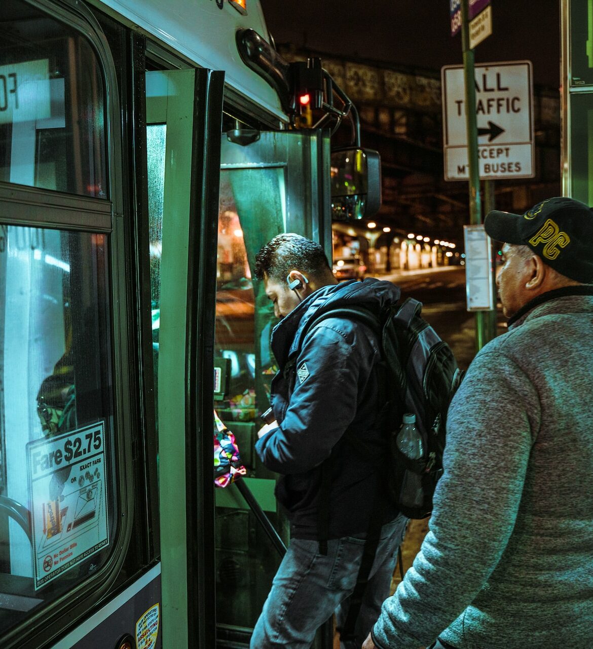 Two passengers board a night bus in Brooklyn, NY