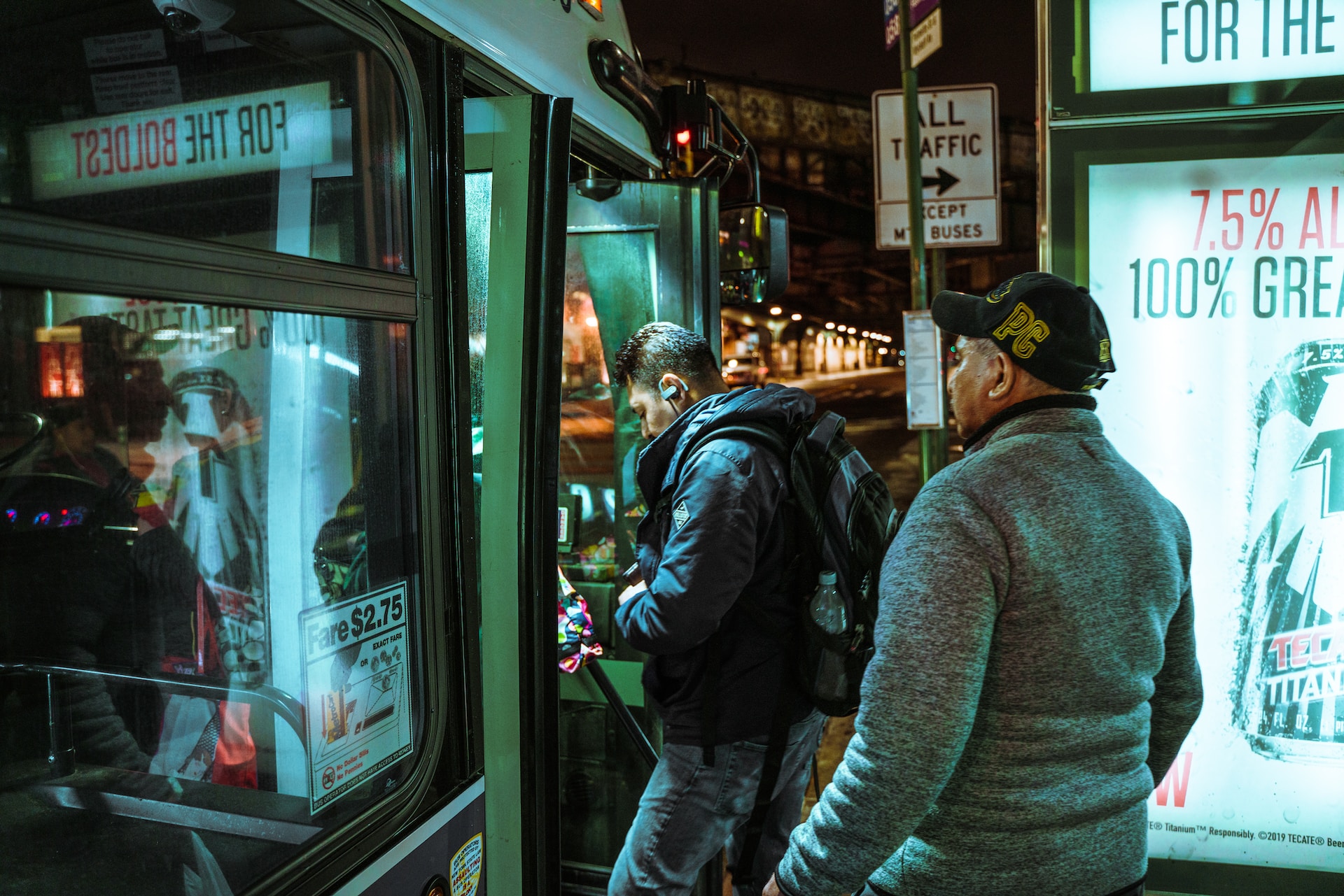Two passengers board a night bus in Brooklyn, NY