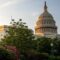 The sun rises behind the U.S. Capitol, casting the dome in a golden glow