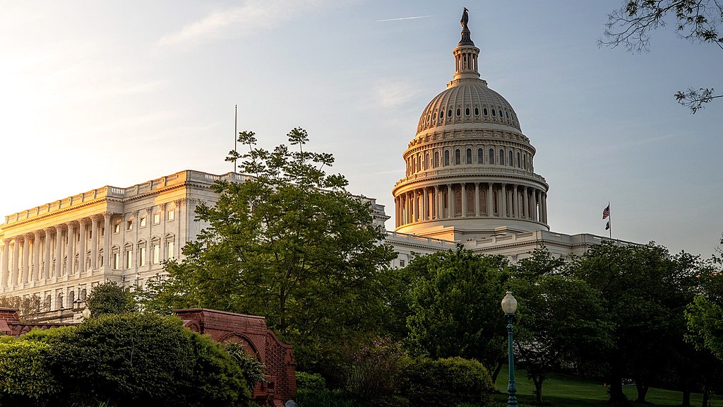 The sun rises behind the U.S. Capitol, casting the dome in a golden glow