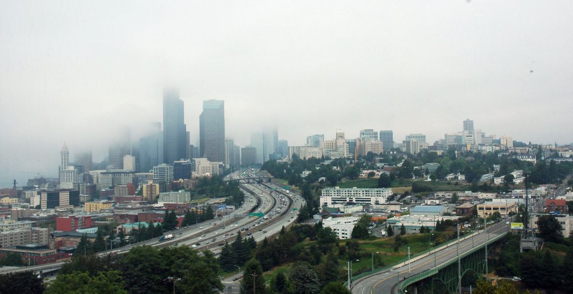 A freeway laces through Seattle as smog descends on the city's skyline