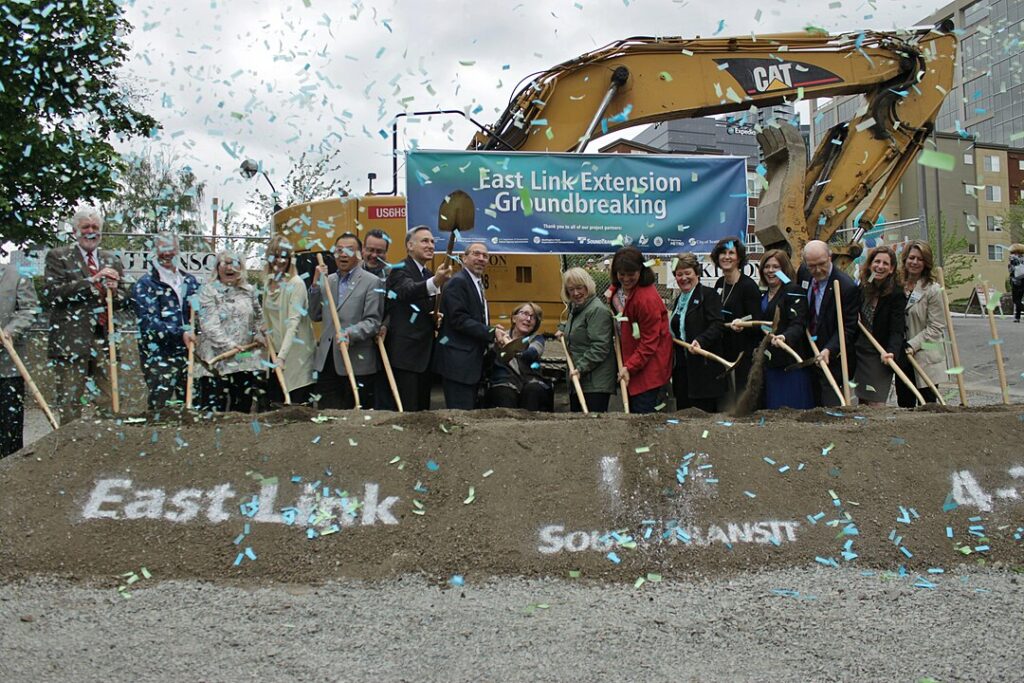 A group of Bellevue city leaders and stakeholders lift their shovels to break ground for the new extension