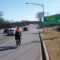 A cyclist travels down a busy highway on their way to Baltimore.