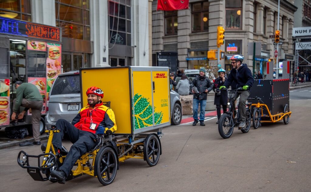 A cyclist rides his cargo-bike down a New York Street