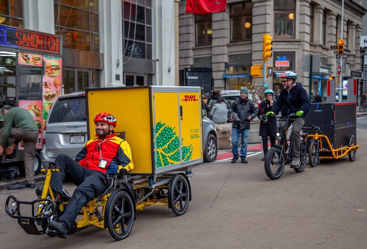 A cyclist rides his cargo-bike down a New York Street