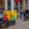 A cyclist rides his cargo-bike down a New York Street