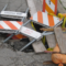 A pothole filled with caution signs