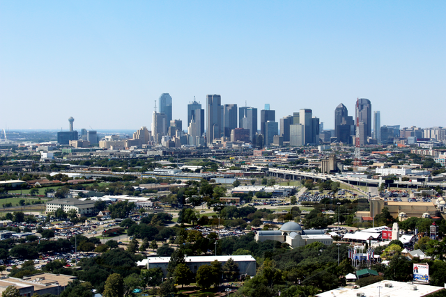 Tall buildings and development in the foreground of the Dallas–Fort Worth metro area.