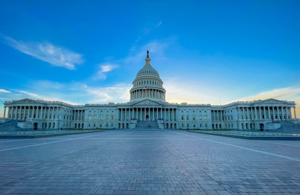 U.S. Capitol building against blue sky.